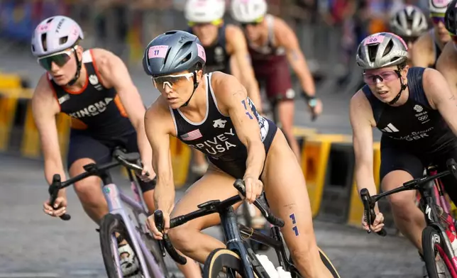 Taylor Spivey, of the United States, competes during the bike leg of the women's individual triathlon competition at the 2024 Summer Olympics, Wednesday, July 31, 2024, in Paris, France. (AP Photo/David Goldman)