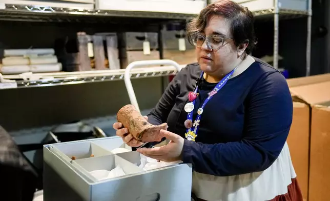 The Parthenon's Registrar and Assistant Curator Bonnie Seymour packs a pre-Columbian artifact from Mexico into boxes Tuesday, July 2, 2024, in Nashville, Tenn. The museum is working to repatriate the items back to Mexico. (AP Photo/George Walker IV)