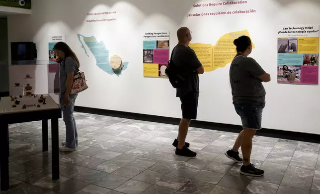 Guests visit the exhibit 'Repatriation and its Impact' at The Parthenon, Tuesday, July 2, 2024, in Nashville, Tenn. The museum is working to repatriate pre-Columbian artifacts back to Mexico. (AP Photo/George Walker IV)