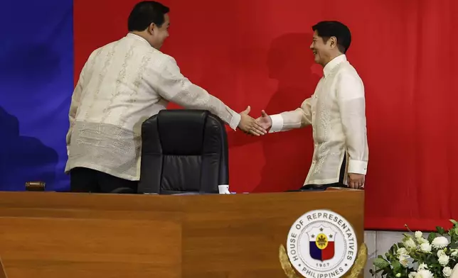 Philippines President Ferdinand Marcos Jr. right, shakes hands with House Speaker Martin Romualdez ahead of the State of the Nation Address at the House of Representatives in Quezon City, Philippines, on Monday, July 22, 2024. (AP Photo/ Gerard V. Carreon)