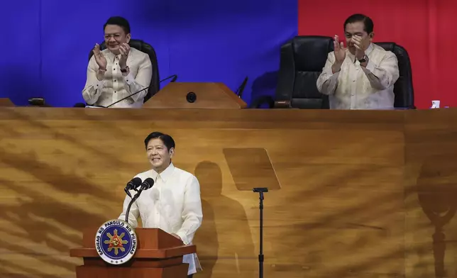 Philippine President Ferdinand Marcos Jr. delivers his third State of the Nation Address as Senate President Francis Escudero, left and House Speaker Martin Romualdez, right, applaud at the House of Representatives in Quezon City, Philippines, on Monday, July 22, 2024. (AP Photo/ Gerard V. Carreon)