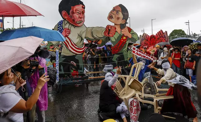 An effigy of Philippine President Ferdinand Marcos Jr. and Philippine Vice President Sara Duterte are displayed during a rally ahead of the third State of the Nation Address in Quezon City, Philippines, Monday, July 22, 2024. (AP Photo/Mark Cristino)