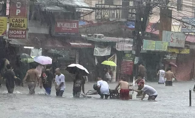 Streets flooded as monsoon rains worsened by offshore typhoon Gaemi on Wednesday, July 24, 2024, in Manila, Philippines. (AP Photo/Joeal Capulitan)