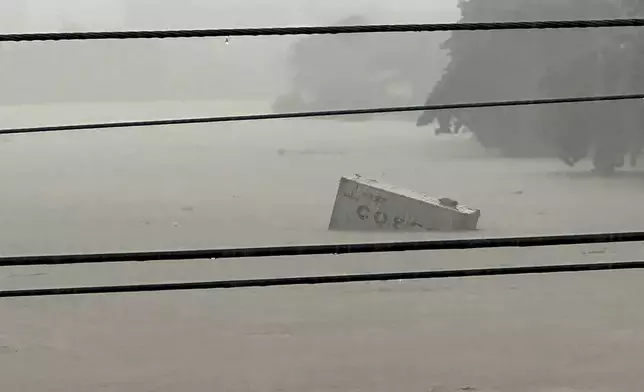 A container floats on swollen Marikina River as monsoon rains worsened by offshore typhoon Gaemi on Wednesday, July 24, 2024, in Manila, Philippines. (AP Photo/Joeal Capulitan)