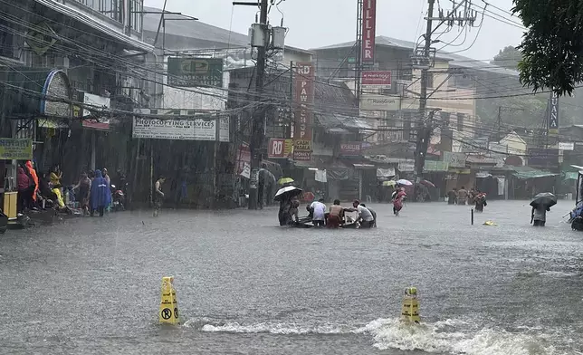 Streets flooded as monsoon rains worsened by offshore typhoon Gaemi on Wednesday, July 24, 2024, in Manila, Philippines. (AP Photo/Joeal Capulitan)