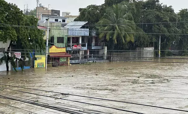 Marikina River swells as monsoon rains worsened by offshore typhoon Gaemi on Wednesday, July 24, 2024, in Manila, Philippines. (AP Photo/Joeal Capulitan)