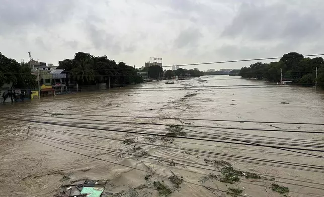 Marikina River swells as monsoon rains worsened by offshore typhoon Gaemi on Wednesday, July 24, 2024, in Manila, Philippines. (AP Photo/Joeal Capulitan)