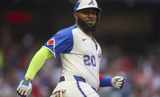 Atlanta Braves designated hitter Marcell Ozuna reacts after a two-run home run in the first inning of a baseball game against the Philadelphia Phillies, Saturday, July 6, 2024, in Atlanta. (AP Photo/Brett Davis)