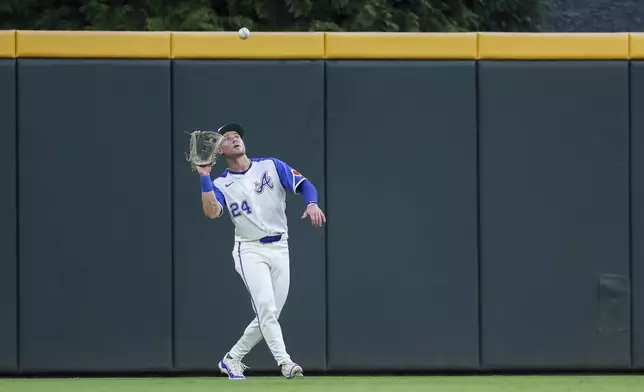 Atlanta Braves center fielder Jarred Kelenic catches a fly ball in the third inning of a baseball game against the Philadelphia Phillies, Saturday, July 6, 2024, in Atlanta. (AP Photo/Brett Davis)