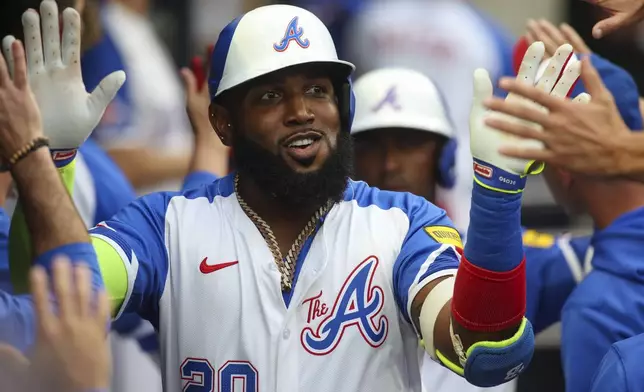 Atlanta Braves designated hitter Marcell Ozuna (20) celebrates with teammates after a two-run home run in the first inning of a baseball game against the Philadelphia Phillies, Saturday, July 6, 2024, in Atlanta. (AP Photo/Brett Davis)