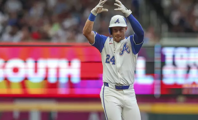 Atlanta Braves' Jarred Kelenic reacts after hitting a ground-rule double in the first inning of a baseball game against the Philadelphia Phillies, Saturday, July 6, 2024, in Atlanta. (AP Photo/Brett Davis)