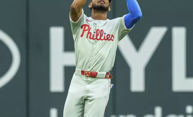 Philadelphia Phillies outfielder Johan Rojas catches a pop fly in the first inning of a baseball game against the Atlanta Braves, Friday, July 5, 2024, in Atlanta. (AP Photo/Jason Allen)