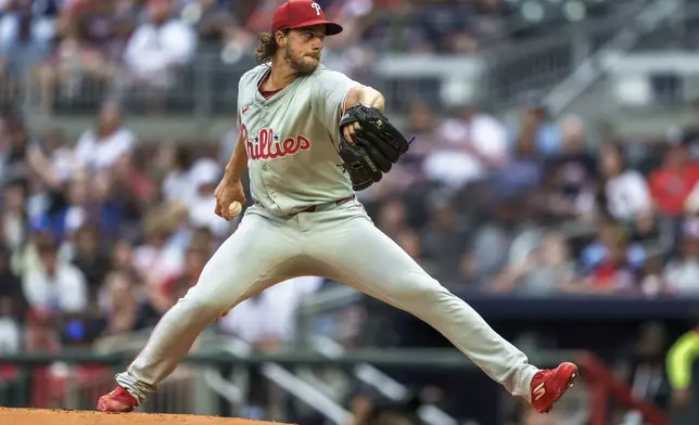 Philadelphia Phillies pitcher Aaron Nola throws in the first inning of a baseball game against the Atlanta Braves, Friday, July 5, 2024, in Atlanta. (AP Photo/Jason Allen)