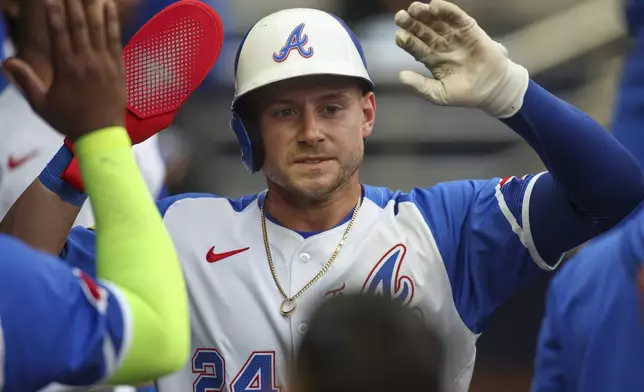 Atlanta Braves' Jarred Kelenic (24) celebrates with teammates after scoring a run in the first inning of a baseball game against the Philadelphia Phillies, Saturday, July 6, 2024, in Atlanta. (AP Photo/Brett Davis)