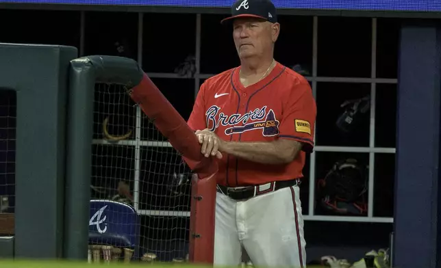 Atlanta Braves manager Brian Snitker watches the playing field in the sixth inning of a baseball game against the Philadelphia Phillies, Friday, July 5, 2024, in Atlanta. (AP Photo/Jason Allen)