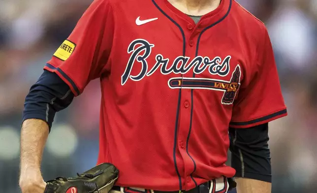 Atlanta Braves pitcher Max Fried checks the scoreboard in the fourth inning of a baseball game against the Philadelphia Phillies, Friday, July 5, 2024, in Atlanta. (AP Photo/Jason Allen)