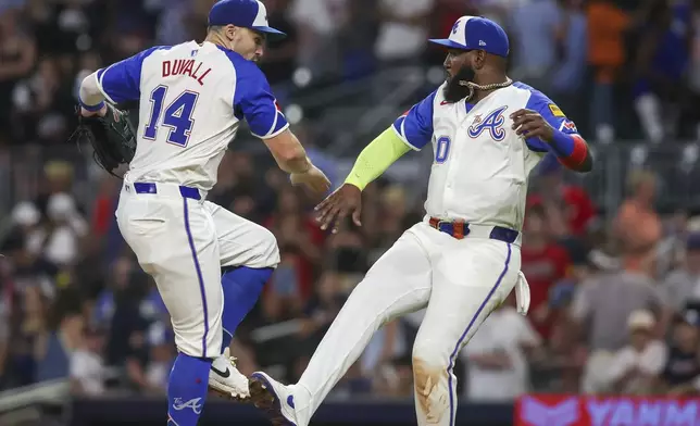 Atlanta Braves' Adam Duvall (14) celebrates with Marcell Ozuna, right, after a 5-1 victory over the Philadelphia Phillies in a baseball game, Saturday, July 6, 2024, in Atlanta. (AP Photo/Brett Davis)