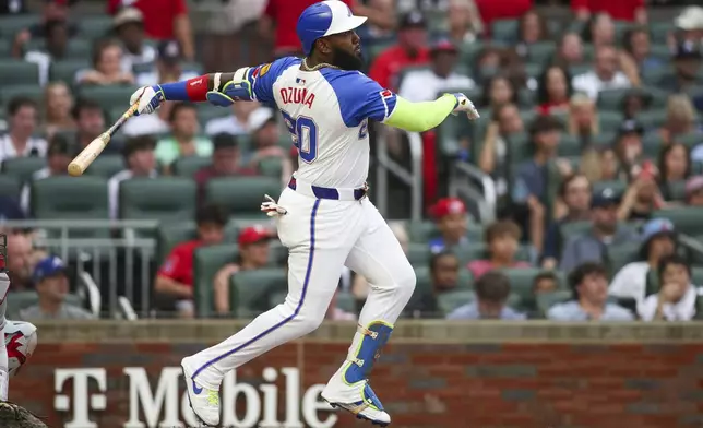 Atlanta Braves designated hitter Marcell Ozuna hits a two-run home run in the first inning of a baseball game against the Philadelphia Phillies, Saturday, July 6, 2024, in Atlanta. (AP Photo/Brett Davis)