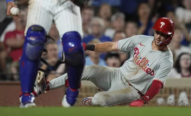 Philadelphia Phillies Trea Turner scores on a sacrifice fly from Edmundo Sosa during the eighth inning of a baseball game against the Chicago Cubs, Wednesday, July 3, 2024, in Chicago. (AP Photo/Erin Hooley)