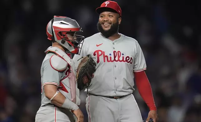 Philadelphia Phillies catcher Rafael Marchán, left, and pitcher José Alvarado celebrate their 5-3 win over the Chicago Cubs in a baseball game Wednesday, July 3, 2024, in Chicago. (AP Photo/Erin Hooley)