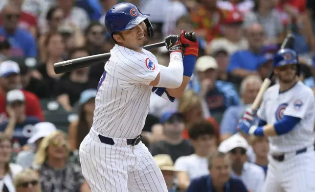 Chicago Cubs' Seiya Suzuki watches his single during the fifth inning of a baseball game against the Philadelphia Phillies, Thursday, July 4, 2024, in Chicago. (AP Photo/Paul Beaty)