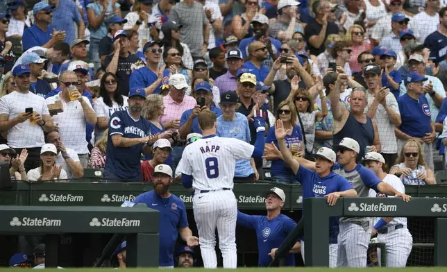 Chicago Cubs' Ian Happ (8) celebrates with manager Craig Counsell, center right, at the dugout after hitting a three-run home run during the fourth inning of a baseball game against the Philadelphia Phillies, Thursday, July 4, 2024, in Chicago. (AP Photo/Paul Beaty)
