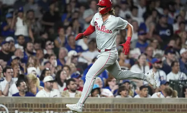 Philadelphia Phillies' Alec Bohm runs the bases to score on a single from Whit Merrifield during the eighth inning of a baseball game against the Chicago Cubs, Wednesday, July 3, 2024, in Chicago. (AP Photo/Erin Hooley)