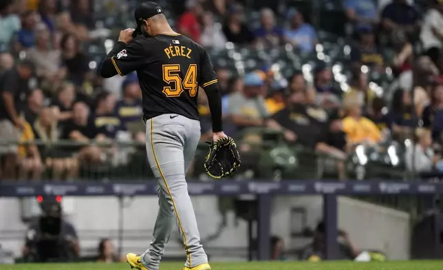 Pittsburgh Pirates' Martín Pérez walks to the dugout after being removed during the fifth inning of a baseball game against the Milwaukee Brewers, Wednesday, July 10, 2024, in Milwaukee. (AP Photo/Aaron Gash)