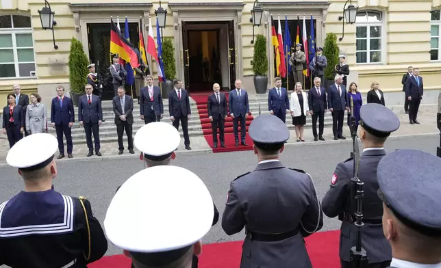 German Chancellor Olaf Scholz, center left, and Polish Prime Minister Donald Tusk, center right, review the guard of honor before German-Polish inter-governmental consultations in front of Prime Minister Chancellery in Warsaw, Poland, Tuesday, July 2, 2024. (AP Photo/Czarek Sokolowski)