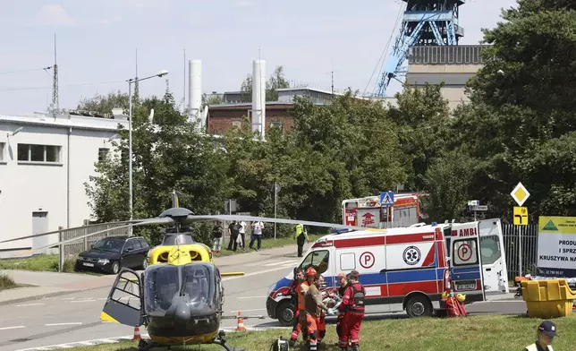 Rescuers transport an injured miner to an airborne ambulance near the Rydultowy coal mine near the city of Rybnik, in southern Poland, Thursday, July 11, 2024. Two Polish coal miners were unaccounted for and at least 15 were injured after a powerful tremor shook the Rydultowy coal mine about 1,200 meters (4,000 feet) underground on Thursday, officials said. Rescuers struggled to reach about two dozen others. (AP Photo/Katarzyna Zaremba-Majcher)