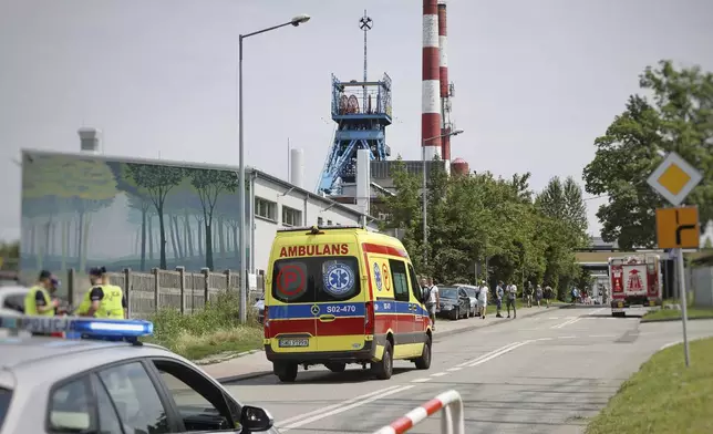 An ambulance heads into the Rydultowy coal mine near the city of Rybnik, in southern Poland, on Thursday, July 11, 2024. Officials say that two Polish coal miners remain unaccounted for and at least 15 have been injured after a powerful tremor shook the Rydultowy coal mine. Rescuers are struggling to reach dozens of others. (AP Photo/Katarzyna Zaremba-Majcher)