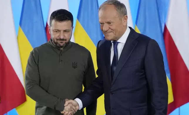 Poland's Prime Minister Donald Tusk, right, and Ukrainian President Volodymyr Zelenskyy shake hands during their meeting in Warsaw, Poland, Monday, July 8, 2024. (AP Photo/Czarek Sokolowski)