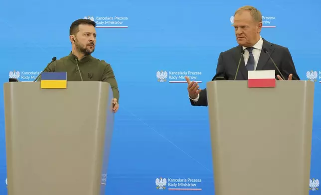 Ukrainian President Volodymyr Zelenskyy, left, and Poland's Prime Minister Donald Tusk attend a news conference as they meet in Warsaw, Poland, Monday, July 8 , 2024. (AP Photo/Czarek Sokolowski)