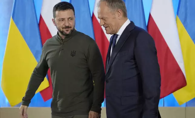 Poland's Prime Minister Donald Tusk, right, and Ukrainian President Volodymyr Zelenskyy walk during their meeting in Warsaw, Poland, Monday, July 8, 2024. (AP Photo/Czarek Sokolowski)