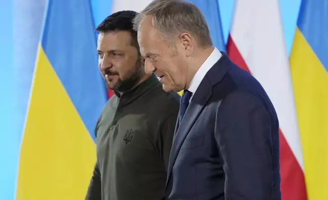 Poland's Prime Minister Donald Tusk, right, and Ukrainian President Volodymyr Zelenskyy walk during their meeting in Warsaw, Poland, Monday, July 8, 2024. (AP Photo/Czarek Sokolowski)