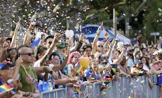 Spectators cheer for beads during the St. Pete Pride festival, Saturday, June 22, 2024 in St. Petersburg, Fla. (Luis Santana/Tampa Bay Times via AP)