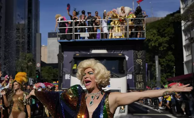 A reveler dances during the annual Gay Pride Parade in Sao Paulo, Sunday, June 2, 2024. (AP Photo/Andre Penner)