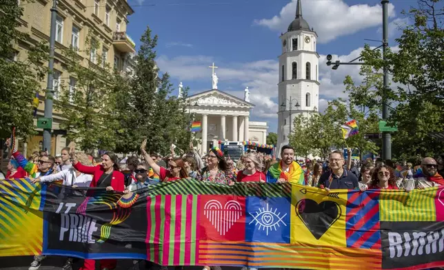 Revelers take part in the Pride March in Vilnius, Lithuania, Saturday, June 8, 2024. (AP Photo/Mindaugas Kulbis)