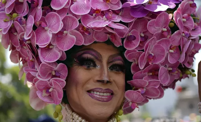 A participant smiles during the annual Pride parade, marking the culmination of LGBTQ+ Pride month, in Mexico City, Saturday, June 29, 2024. (AP Photo/Aurea Del Rosario)