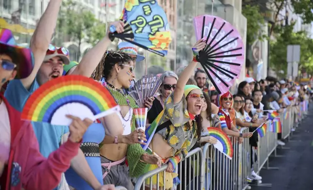 Revelers cheers along the route during a Pride Parade, Sunday, June 30, 2024, in San Francisco. (AP Photo/Ethan Swope)