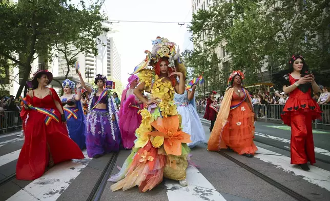 Revelers wear colorful costumes during a Pride Parade, Sunday, June 30, 2024, in San Francisco. (AP Photo/Ethan Swope)