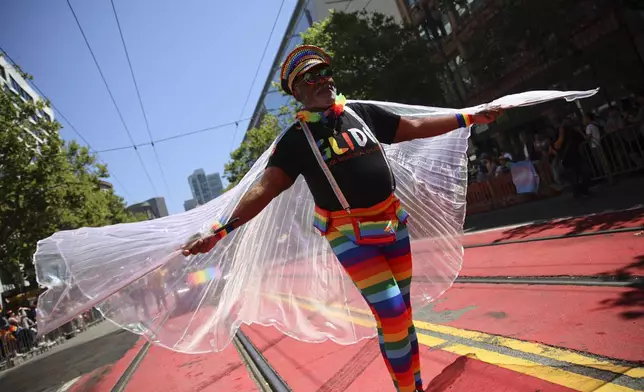 A reveler wears a rainbow-colored outfit during a Pride Parade, Sunday, June 30, 2024, in San Francisco. (AP Photo/Ethan Swope)