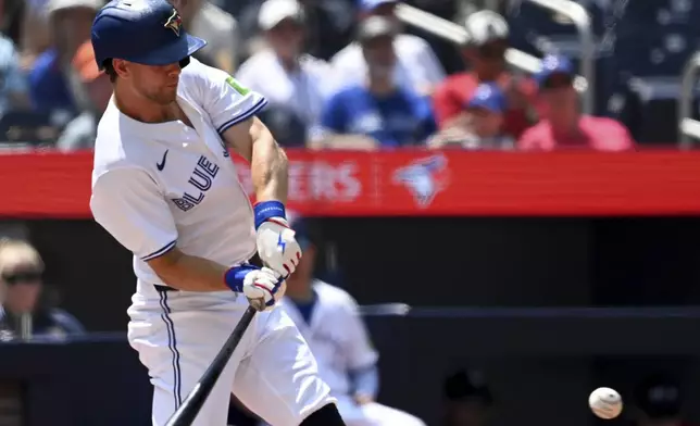 Toronto Blue Jays' Ernie Clement hits a double agains the Texas Rangers in first-inning baseball game action in Toronto, Sunday, July 28, 2024. (Jon Blacker/The Canadian Press via AP)