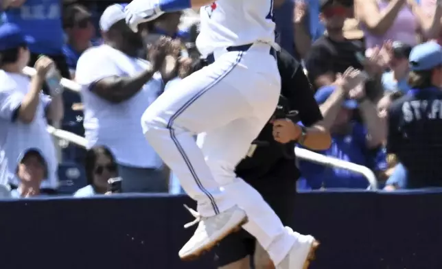 Toronto Blue Jays' Daulton Varsho runs the bases after hitting a two-RBI home run against the Texas Rangers in first-inning baseball game action in Toronto, Sunday, July 28, 2024. (Jon Blacker/The Canadian Press via AP)