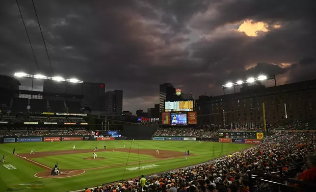 The Baltimore Orioles and the Texas Rangers play during the fifth inning of a baseball game, Sunday, June 30, 2024, in Baltimore. (AP Photo/Nick Wass)