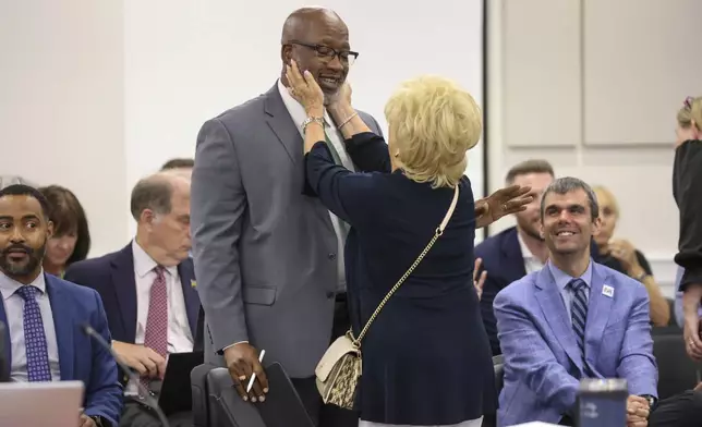 St. Petersburg Mayor Ken Welch visits with Pinellas County Commissioner Janet Long while attending a meeting of the Pinellas County commissioners on Tuesday, July 30, 2024, where they voted for funding for a new Tampa Bay Rays ballpark, in Clearwater, Fla. (Douglas R. Clifford/Tampa Bay Times via AP)