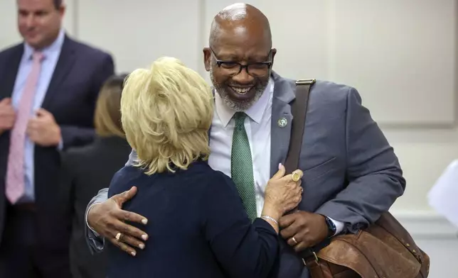 St. Petersburg Mayor Ken Welch visits with Pinellas County Commissioner Janet Long moments after the Pinellas County commissioners voted to fund the new Tampa Bay Rays ballpark during a meeting Tuesday, July 30, 2024, in Clearwater, Fla. (Douglas R. Clifford/Tampa Bay Times via AP)