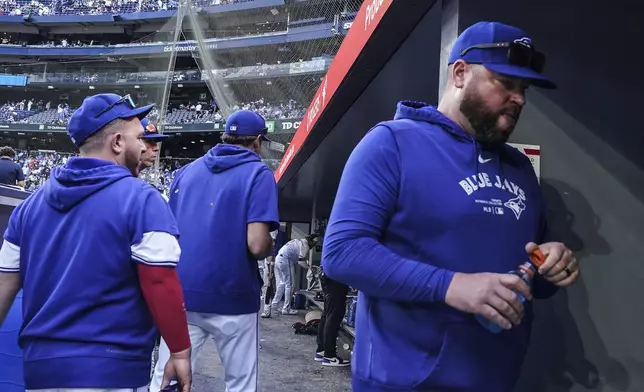 Toronto Blue Jays manager John Schneider, right, leaves the dugout after his team's loss to the Tampa Bay Rays in baseball game action in Toronto, Thursday, July 25, 2024. (Chris Young/The Canadian Press via AP)