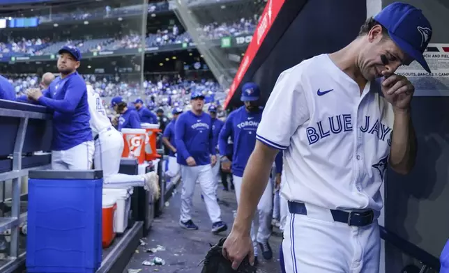 Toronto Blue Jays' Ernie Clement, right, leaves the dugout after his team's loss to the Tampa Bay Rays in baseball game action in Toronto, Thursday, July 25, 2024. (Chris Young/The Canadian Press via AP)