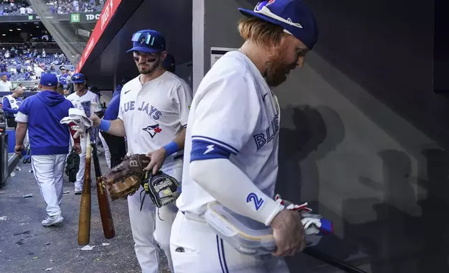 Toronto Blue Jays' Justin Turner, right, and Spencer Horwitz, second from right, leave the dugout after their team's loss to the Tampa Bay Rays in baseball game action in Toronto, Thursday, July 25, 2024. (Chris Young/The Canadian Press via AP)